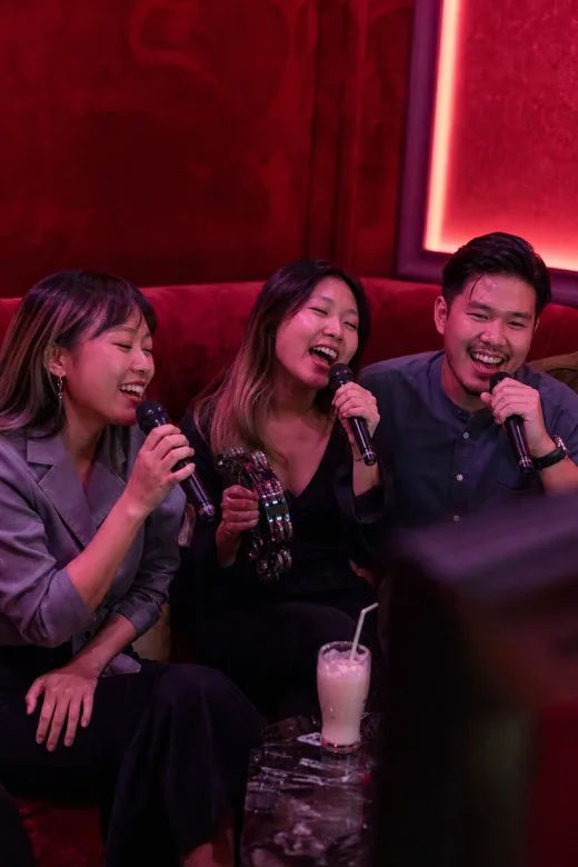 Friends singing in a karaoke room